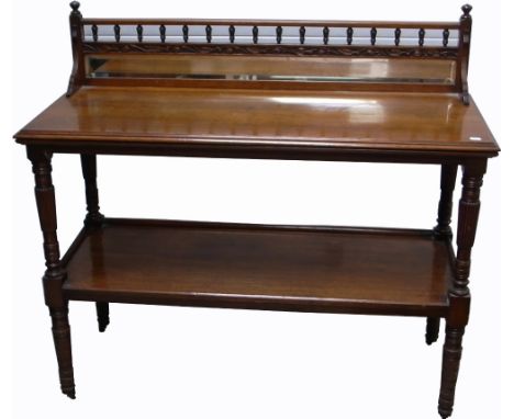 An early 20th century oak breakfast table, top glazed section above lower self with fluted and ring turned supports to castor