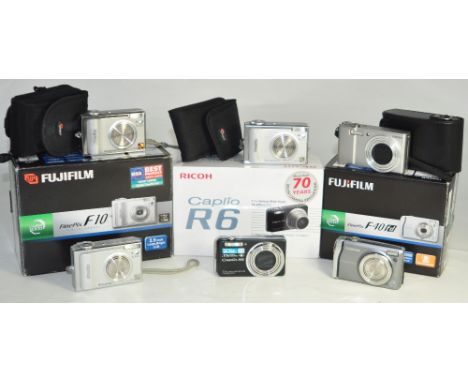 Six compact digital cameras to include a Ricoh Caplio R6, CX1, a Fuji Finepix (6). CONDITION REPORT marks to the casings comm