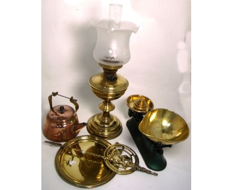 A Victorian brass oil lamp, a copper kettle, a set of early 20th century scales and a further small quantity of brassware.