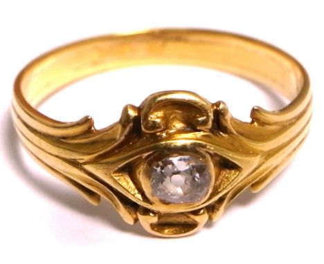 A Edwardian yellow metal scroll ring set with a central white stone, approx weight 2.5g, size O. 