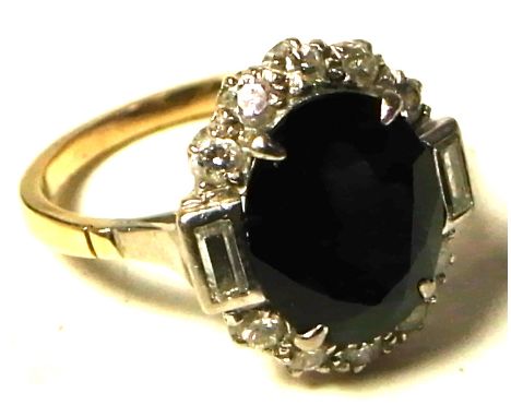 A 9ct gold ring set with large central blue stone and diamond surround, size M, approx weight 4g.