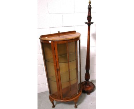 A c.1940s glazed bow front display cabinet on cabriole legs, 116 x 50cm and a mahogany turned standard lamp (2).