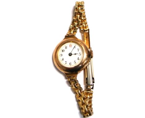 A 9ct gold ladies wristwatch, enamel dial set with Arabic numerals on a rolled gold link bracelet.