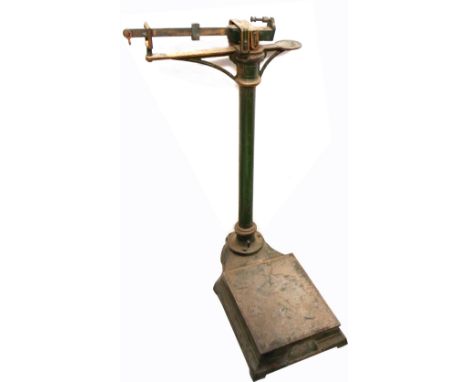 A set of early 20th century free standing green painted scales, height 90cm. 