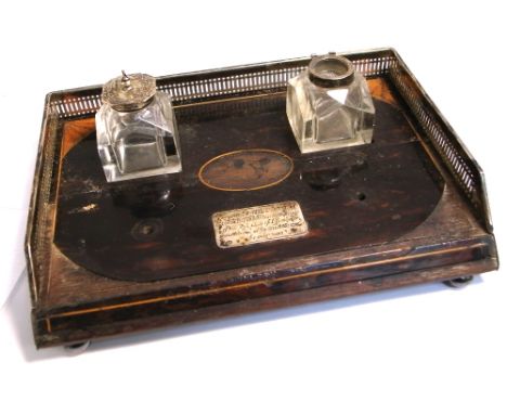 A Victorian coromandel and silver framed desk ink stand, London 1886, with presentation plaque to the front and a pair of ink