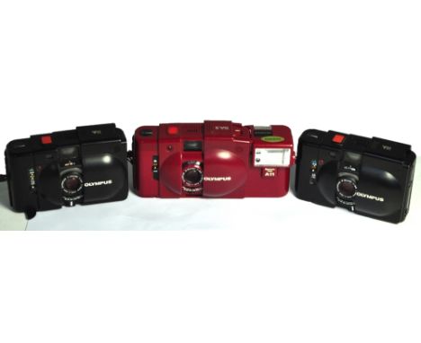 An Olympus XA2 35mm compact camera in red finish with matching flash unit and two XA cameras (3).