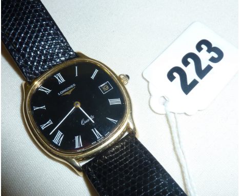 Vintage gentleman's 9ct gold Longines wristwatch with black face and lizard skin strap