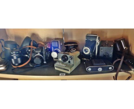 Nine assorted vintage cameras, a light meter and a lens