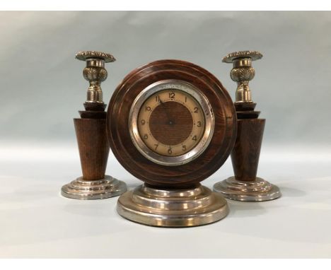 A pair of candle sticks and a clock