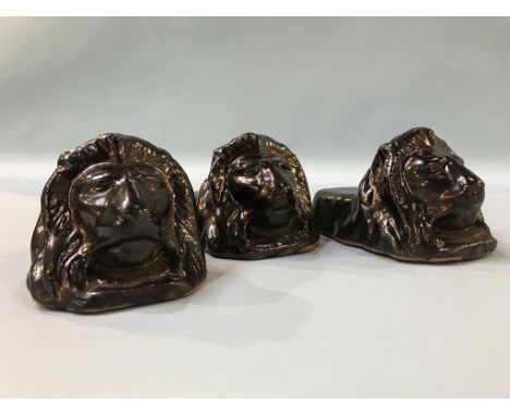 A set of three Victorian 'Lion' pottery sash window rests