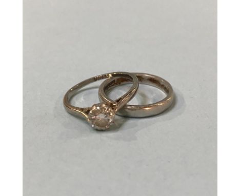 A platinum wedding band (4g) and an 18ct gold ring (2g)