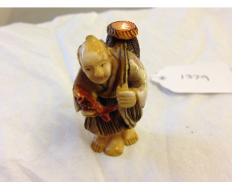 A signed netsuke of a fisherman.