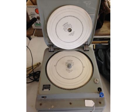 A c1950s Gross cash register with unused paper recorder discs.