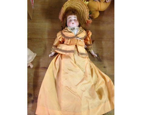 An armande Marseille doll 21.5" (54cm) tall, bisque head, shoulders & limbs with stuffed cloth & period clothing. Head marked