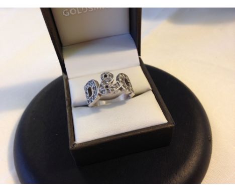 A heavy 925 silver ring with D & G design set with white stones. Size approx Q