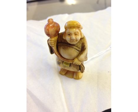 A signed netsuke of a monk with lantern.