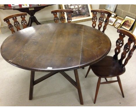 A dark wood Ercol drop leaf table & 4 old Colonial style chairs.