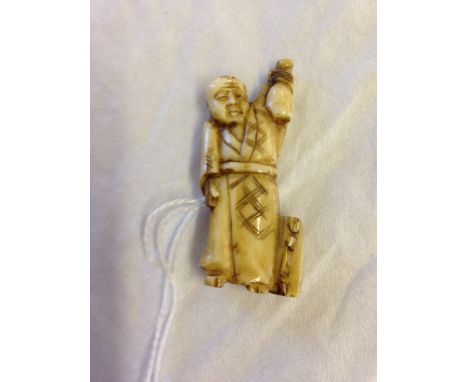 A netsuke of a man holding a gourd aloft.