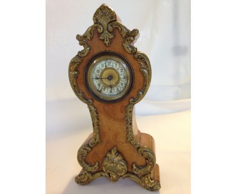 A Victorian gilt and burr walnut mantle clock, possibly French, in working order.