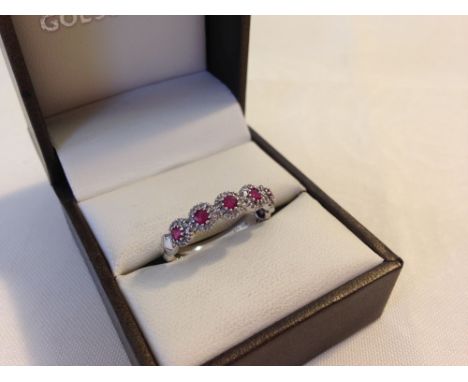Pretty hallmarked 9ct white gold ring set with 5 rubies encircled by small diamonds. Size approx R