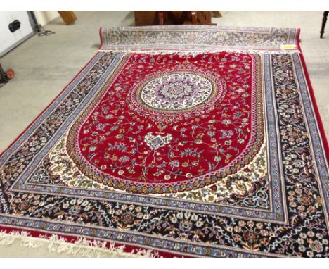 An Iranian red & blue carpet in excellent condition. 2.5 x 3.5m.
