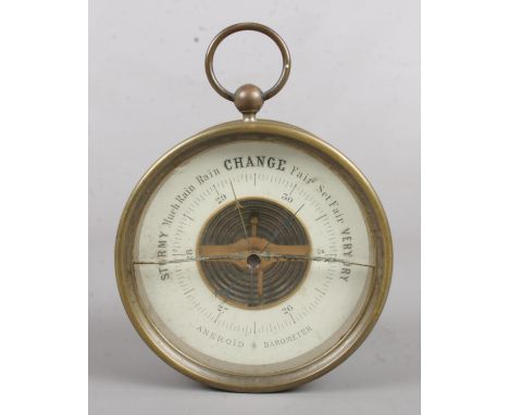 A vintage circular aneroid barometer.  Crack to glass.