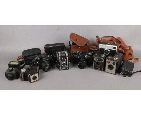 A group of eight vintage cameras and cases. To include Kodak Brownie Model 1, Brownie C six -20, Zenit EM 35mm and Praktica 3