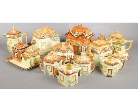 A quantity of ceramic cottageware teawares. Including teapots, jugs, swing handle barrels, etc.  