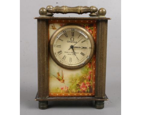 A miniature brass carriage clock. With erotic glass panels. 7cm tall.  Missing winder.