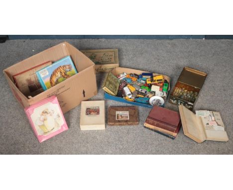 A box of assorted collectables. To include five vintage jigsaws, marbles, diecast vehicles, three books to include the second