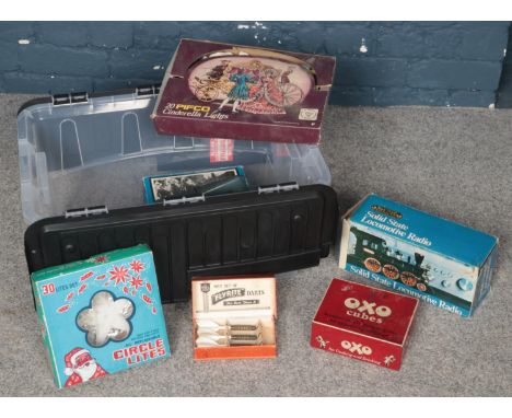 A box of miscellaneous. Vintage Pifco Cinderella Lights, 'Flyrite' boxed darts, Solid State Locomotive Radio (boxed) etc.  