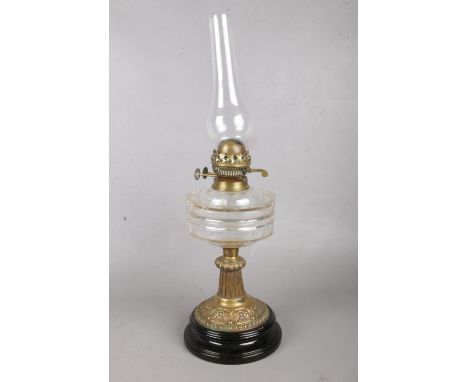 A brass and ceramic oil burner. Comprising of a double duplex burner and glass reservoir. H: 58cm.  Condition fair. Glass res