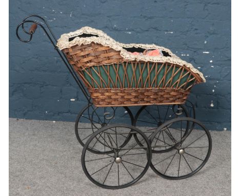 A vintage dolls pram and dolls. 65cm height, 35cm width, 74cm length.  