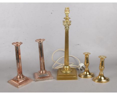A classical designed brass column lamp base, together with two sets of copper and brass candlestick holders. Lamp base H: 45c