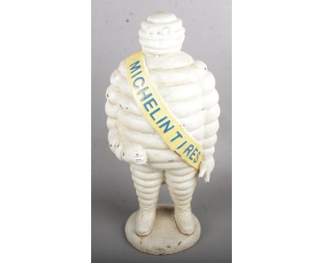 A Cast Iron Michelin Man with Michelin Tires Sash across the Shoulder (56cm Tall).  