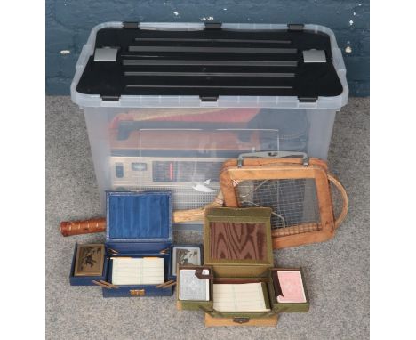 A Box of Assorted Items. To include Two Unopened Bridge Sets, a Battery Powered Radio and a Vintage Dunlop Tennis Racket.  