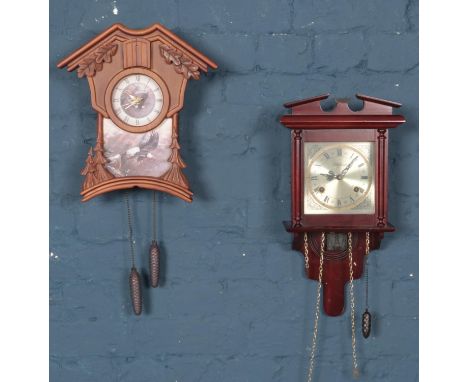 Two wall clocks. Including modern cuckoo clock depicting eagles, etc.  