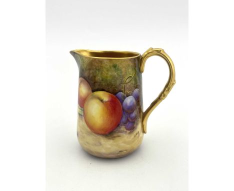 C Smith for Royal Worcester, a fruit painted jug, decorated in the round with apples and grapes, gilt interior and handle, 10