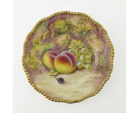 P Stanley for Royal Worcester, a fruit painted plate, decorated with peaches and grapes, within a gilt gadrooned border, blac