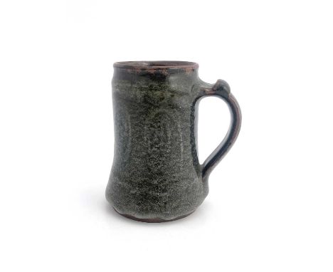 Gugong Bong, an Abuja studio pottery mug, circa 1967-71, tankard form, tenmoku glazed with spiral design to the body, conical