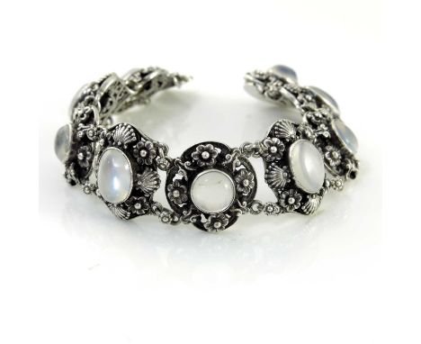 Attributed to Sibyl Dunlop, an Arts and Crafts silver and moonstone bracelet, interlinked foliate and floral panels with cent