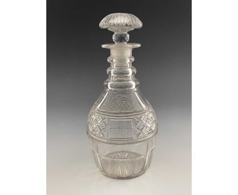 A George III cut glass decanter, circa 1810, three ring neck Prussian form, the central hatched and star cut hobnail band wit