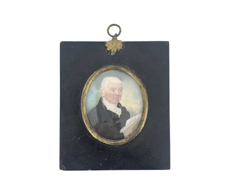 A 19th century portrait miniature, circa 1820, depicting a lawyer in black coat holding a book, short white hair, oval, 7.5cm