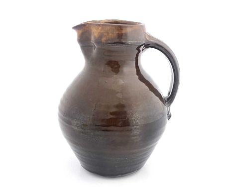 Leach Pottery, a St Ives studio pottery jug, circa 1940, treacle glazed bulbous form, impressed seal mark, 26.5cm high