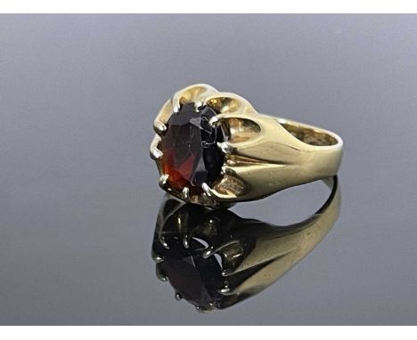 A 9 carat gold and garnet ring, claw set oval stone, size R, 6.3g