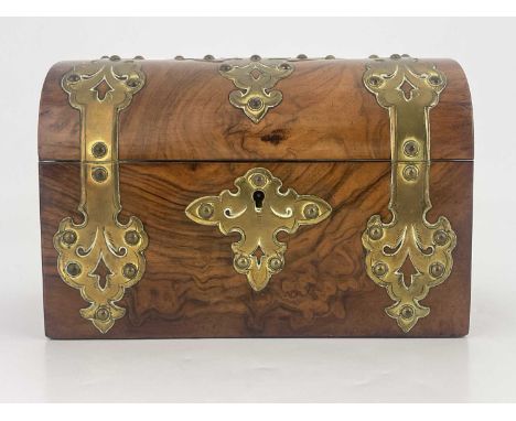 A mid Victorian figured walnut tea caddy, circa 1860, domed hinged cover with fretwork brass Gothic mounts and escutcheon, fi