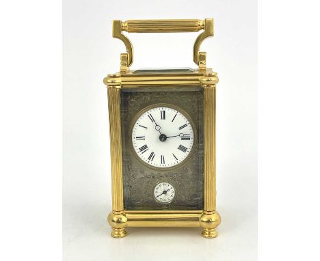 A French carriage alarm clock, early 20th Century, gilt metal case with reeded columns, swing handle, visible escapement, whi