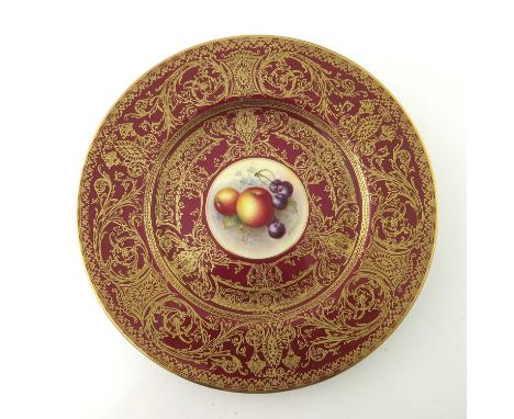 E Townsend for Royal Worcester, a fruit painted plate, decorated with apples and cherries within a red ground raised gilt fol