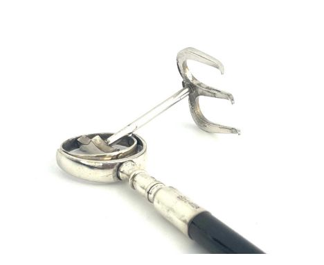 A George V toasting fork, with ebonised rosewood shaft, the fork secured via a gimble mechanism, the silver ferrule inscribed
