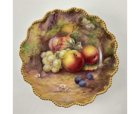 H Price for Royal Worcester, a fruit painted plate, decorated with apples and grapes, within a gilt gadrooned border, puce ma